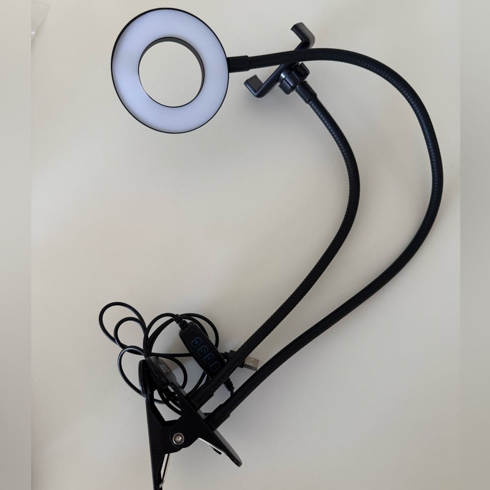 Clip on adjustable ring light with USB connection, and adjustable phone holder.